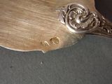 a silver spoon with a silver handle on a table