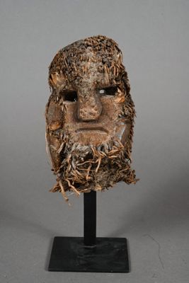 an image of a sculpture of a man ' s face on a black stand