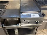 a large stainless steel grill in a commercial kitchen