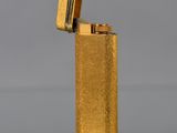 a close up of a lighter on a table with a gray background