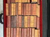 a suitcase full of old books sitting on the floor