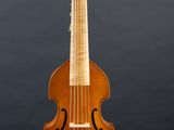 an old violin on a stand against a gray background