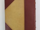 a brown and yellow book on a white surface