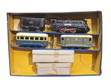 four toy trains in a box on a white background