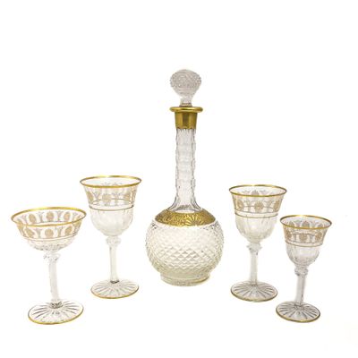 five wine glasses and a decanter on the table