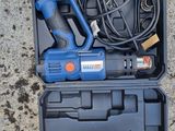 a tool in the case on the ground with a cord