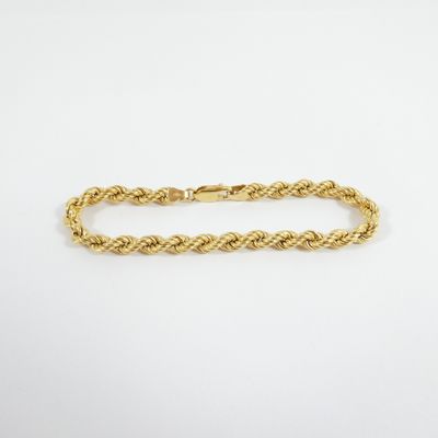 a gold rope bracelet with a clasp on a white background