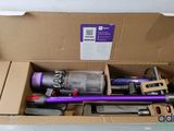 a box with a vacuum and other items inside of it