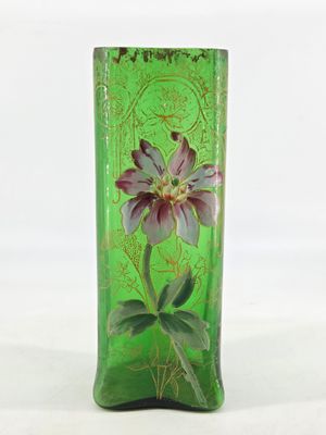 a green vase with a purple flower on it