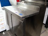 a stainless steel counter in a kitchen with a fire extinguisher