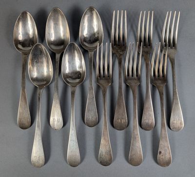 a lot of silver spoons and forks on the table