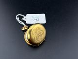a close up of a gold locke with a tag on it