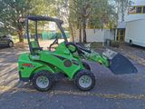 a small green tractor that is parked in the parking lot