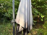 an umbrella that is sitting on a pole in the yard