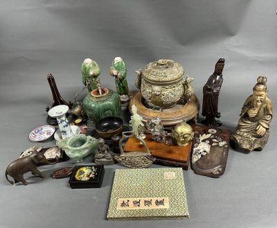 a lot of asian figurines and other items on the table
