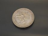 a silver coin with a picture of a man on it
