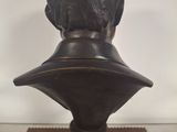a close up of a bronze bust of a man on a pedestal