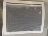 a white air conditioner sitting on top of a counter