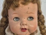 a close up of a doll with a very long hair