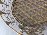 a metal basket with a mirror on top of it