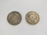 two silver coins, one of which is a sovereign and the other of which is a sovereign