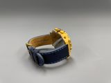 an image of a watch on a white surface with a blue strap