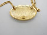 an image of a gold plated necklace with a chain on a white surface