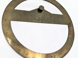 a metal circle with a ruler in it on a white surface