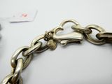 an image of a close up of a chain bracelet on a table
