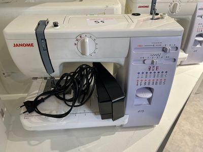 a sewing machine sitting on a table with other machines
