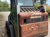 a small tractor that is parked on the side of the road
