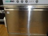 stainless steel dishwasher sitting on top of a wooden floor in a kitchen