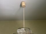 a chandelier made out of plastic plates hanging from the ceiling