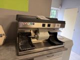 a coffee machine sitting on a counter in a kitchen