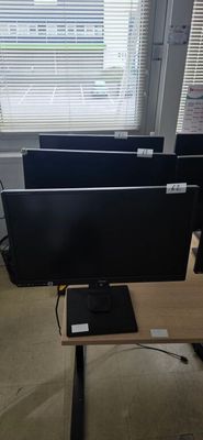 a computer desk with three monitors and a laptop on it
