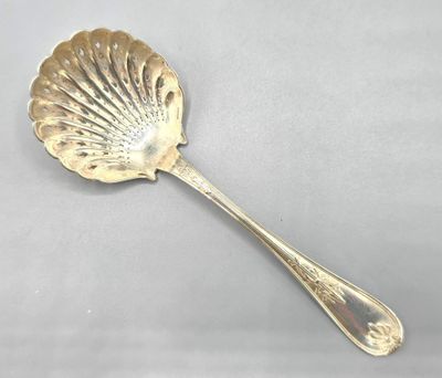 a close up of a spoon on a table with a white background