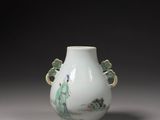a white vase with a green decoration on it