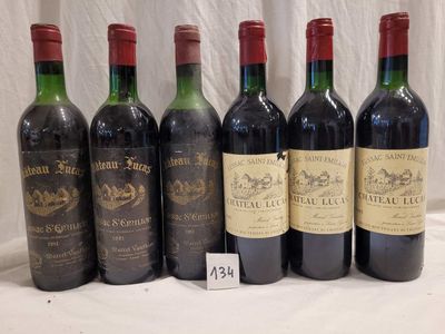 several bottles of wine are lined up on a table