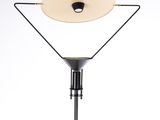 a black and white floor lamp with a white shade on top of it