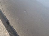 the car is parked on the side of the road with its door open