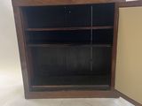 an image of a small wooden cabinet with a door open