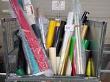 a metal cart filled with wrapping supplies in a garage