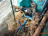 a bike that is sitting in the grass next to a fence