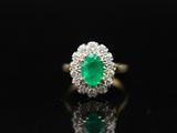an emerald and diamond cluster ring