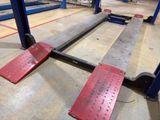a picture of a pair of red metal steps in a warehouse