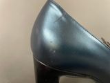 black high heeled shoes with a metal buckle on the heel