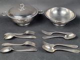a lot of forks and spoons that are on the table