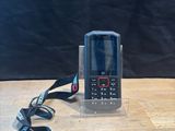 a cell phone sitting on a table next to a lanyard