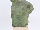 sculpture of a man ' s head on a wooden base