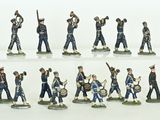 many figurines of men in uniform on a white surface